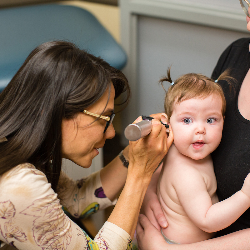 Dr. Larissa checking a babies ears