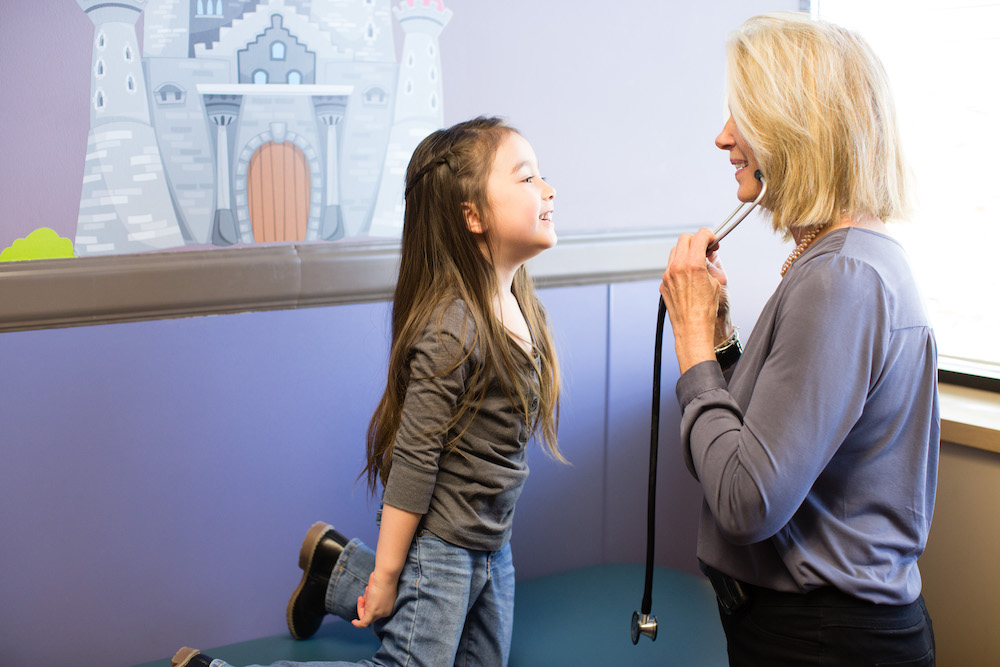 Child smiling at doctor during a checkup