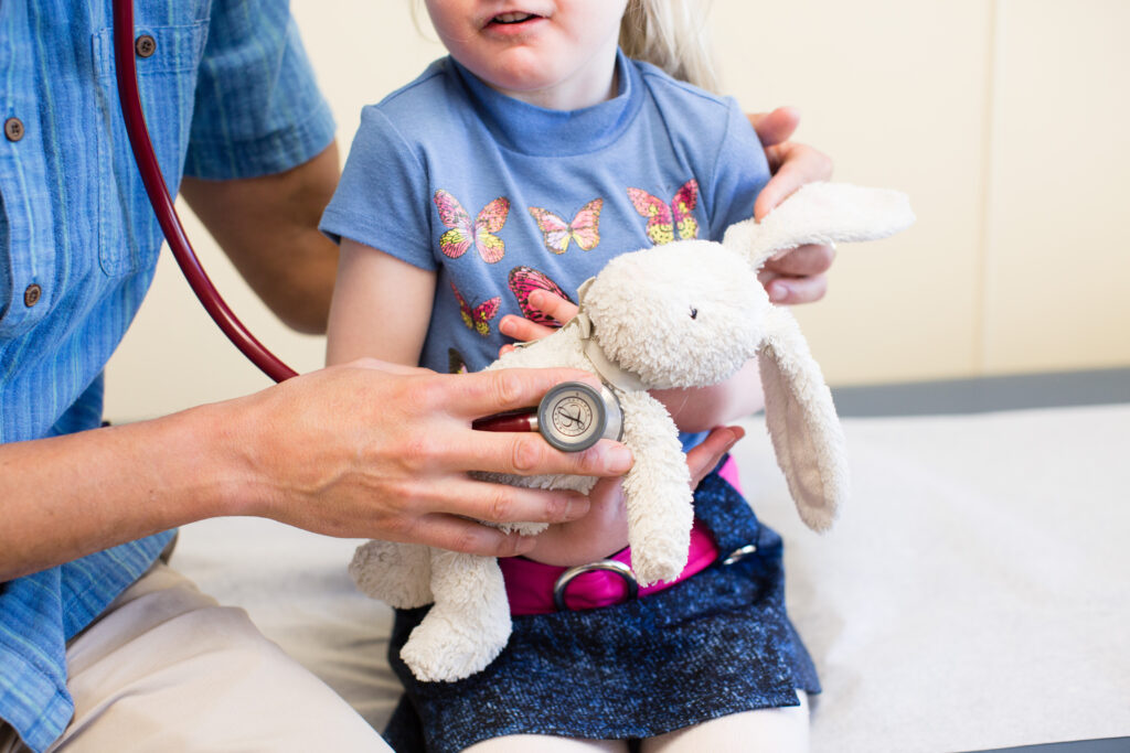 doctor checking on child with asthma